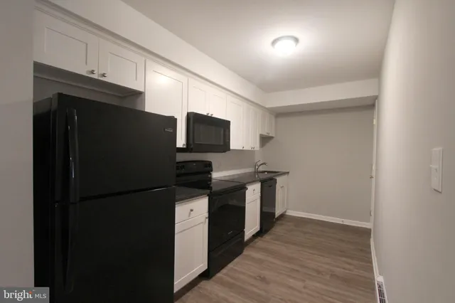 a kitchen with a refrigerator and cabinets