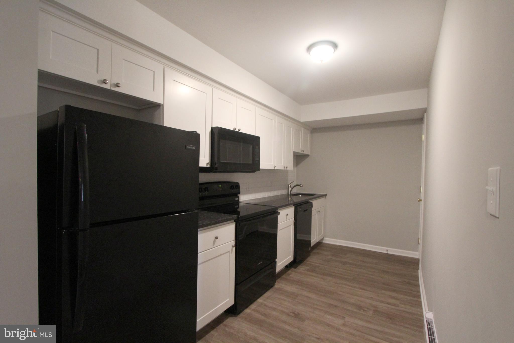 6640 Sprague Street, Unit B5 Philadelphia, PA 19119 - Photo 5 of 16 a kitchen with a refrigerator and cabinets