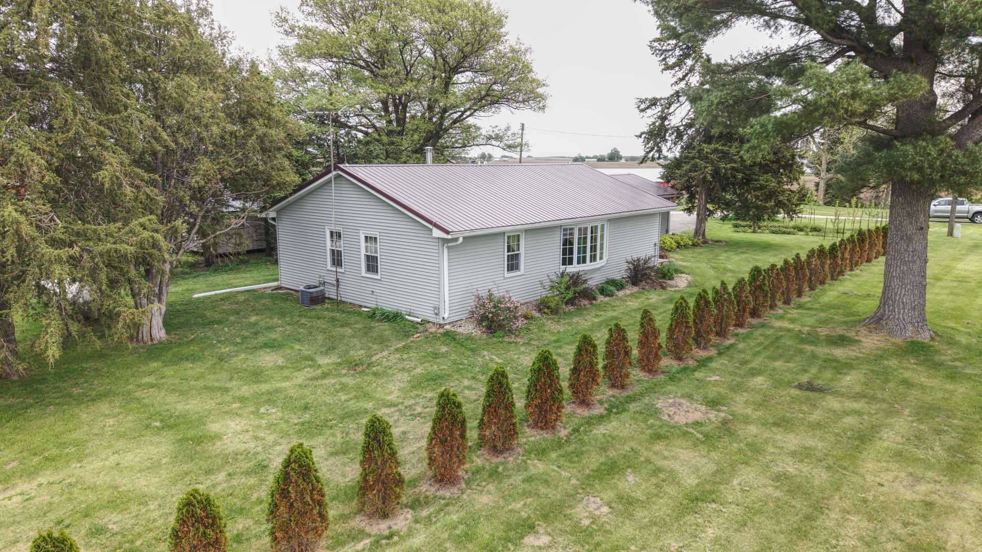 9896 Lincoln Road Morrison, IL 61270 - Photo 3 of 38 a view of a backyard with barn plants and large trees