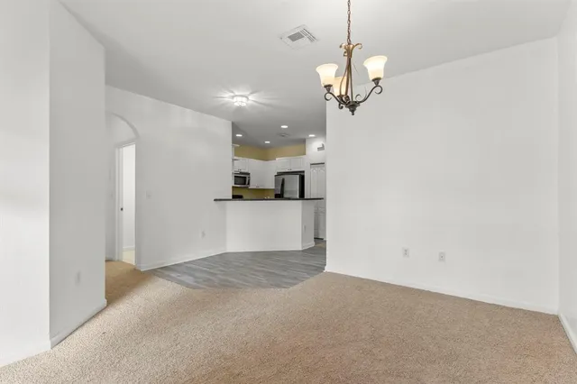 a view of a hallway with a ceiling fan