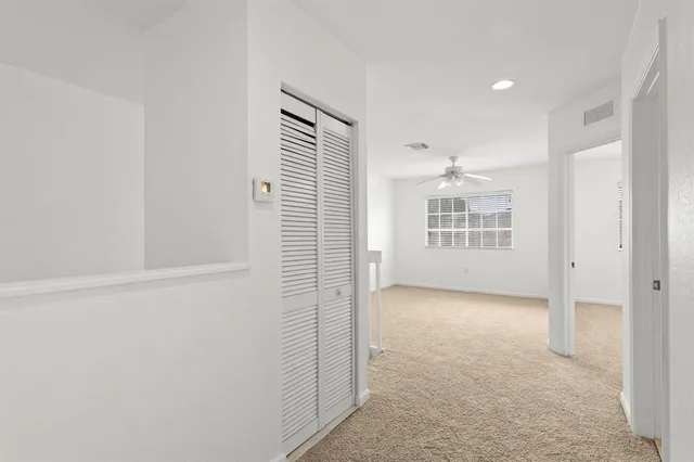 an empty room with windows and closet