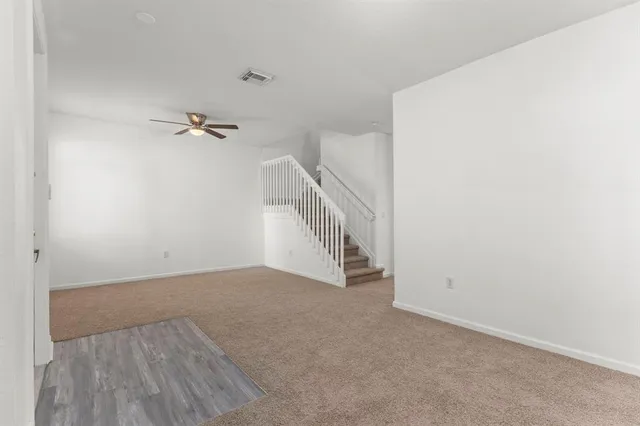 a view of an empty room with a fan