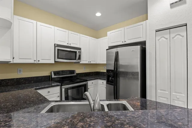 a view of kitchen with furniture and wooden floor