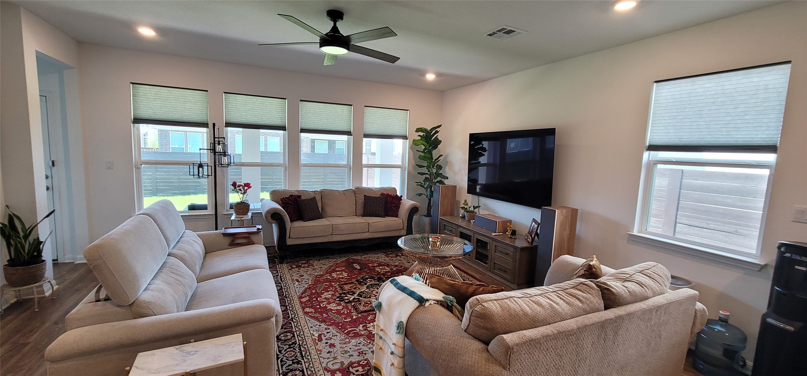 716 Leeward Pass Leander, TX 78641 - Photo 17 of 26 A comfortable living space boasts a ceiling fan, recessed lighting, and ample natural illumination from multiple windows.