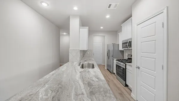 a spacious bathroom with a sink and a mirror