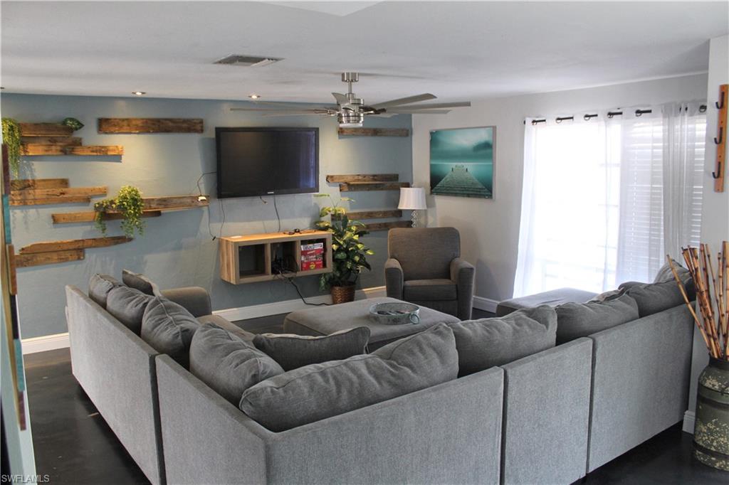 7328 Pebble Beach Road Fort Myers, FL 33967 - Photo 13 of 31 a living room with furniture and a flat screen tv