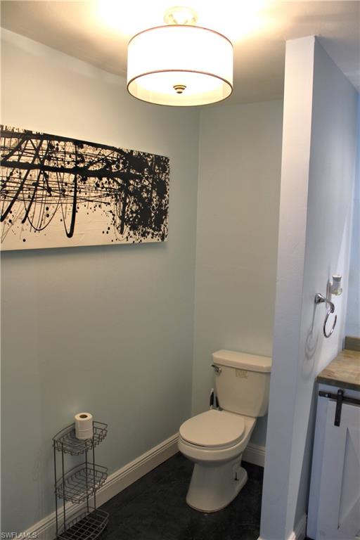 7328 Pebble Beach Road Fort Myers, FL 33967 - Photo 8 of 31 a bathroom with a toilet and a vanity