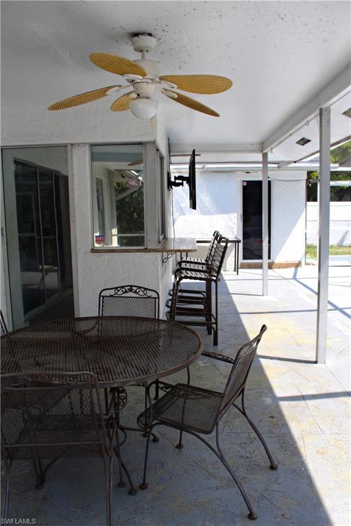 7328 Pebble Beach Road Fort Myers, FL 33967 - Photo 10 of 31 a patio with a table and chairs