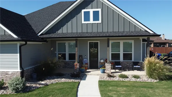 a front view of a house with garden and porch