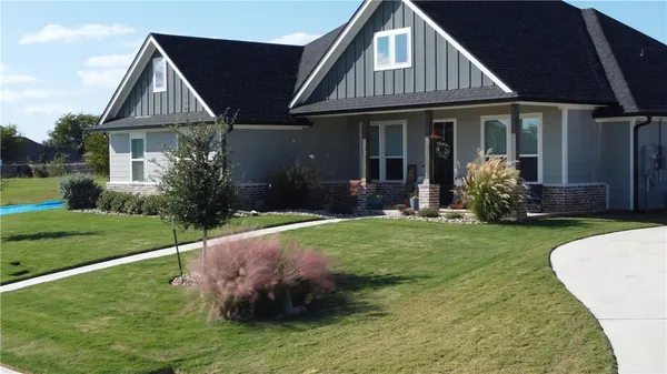 a front view of a house with a yard and porch