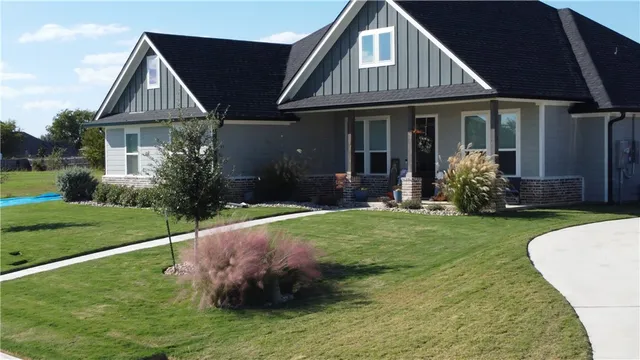a front view of a house with a yard and porch