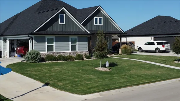 a front view of a house with a yard fire pit and outdoor seating