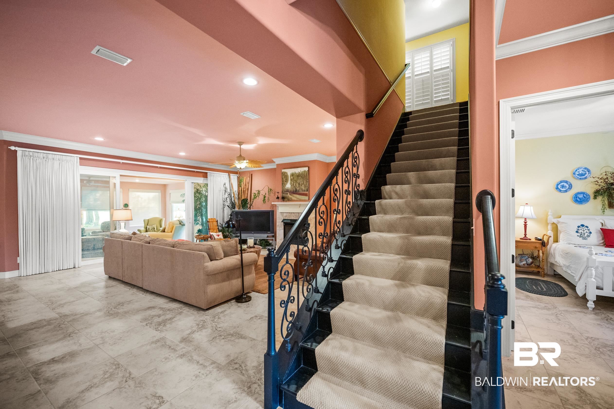 404 Peninsula Boulevard Gulf Shores, AL 36542 - Photo 12 of 51 Stairs featuring ornamental molding, a fireplace, and recessed lighting