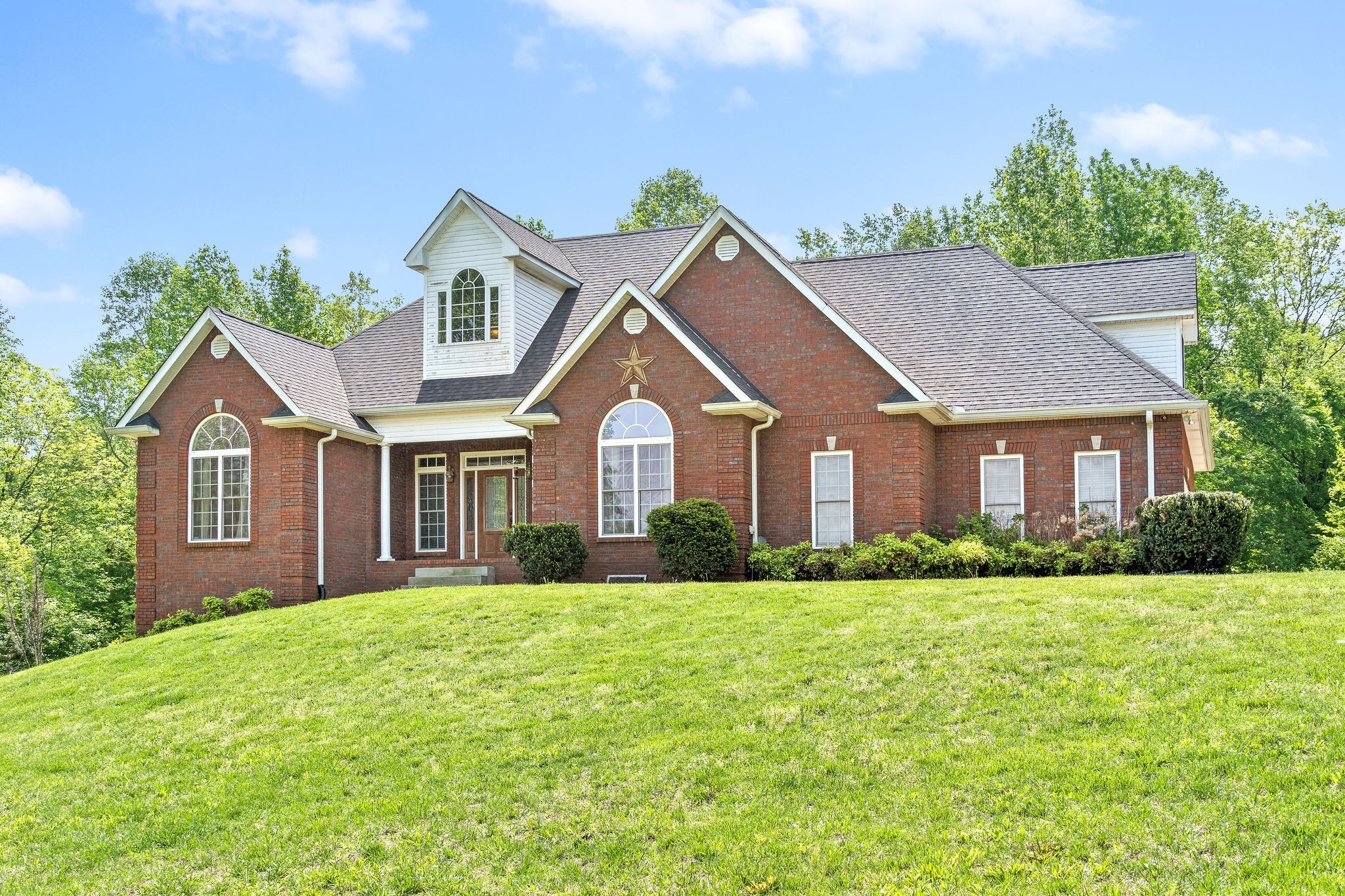 2458 Carroll Road Palmyra, TN 37142 - Photo 1 of 35 a front view of a house with a yard and garage
