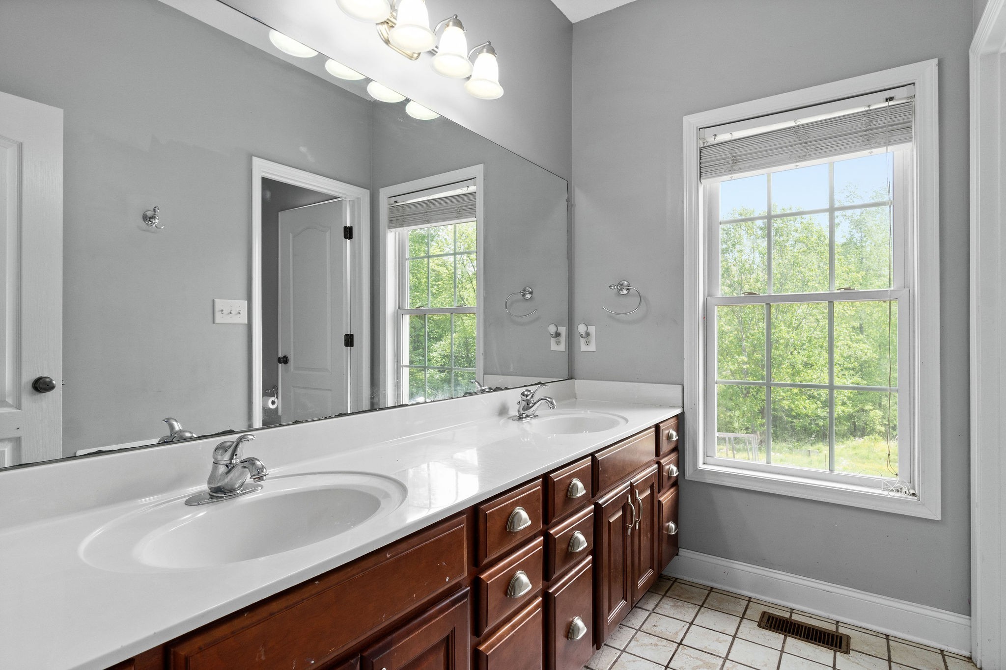 2458 Carroll Road Palmyra, TN 37142 - Photo 26 of 35 a spacious bathroom with a granite countertop sink a large mirror and a window