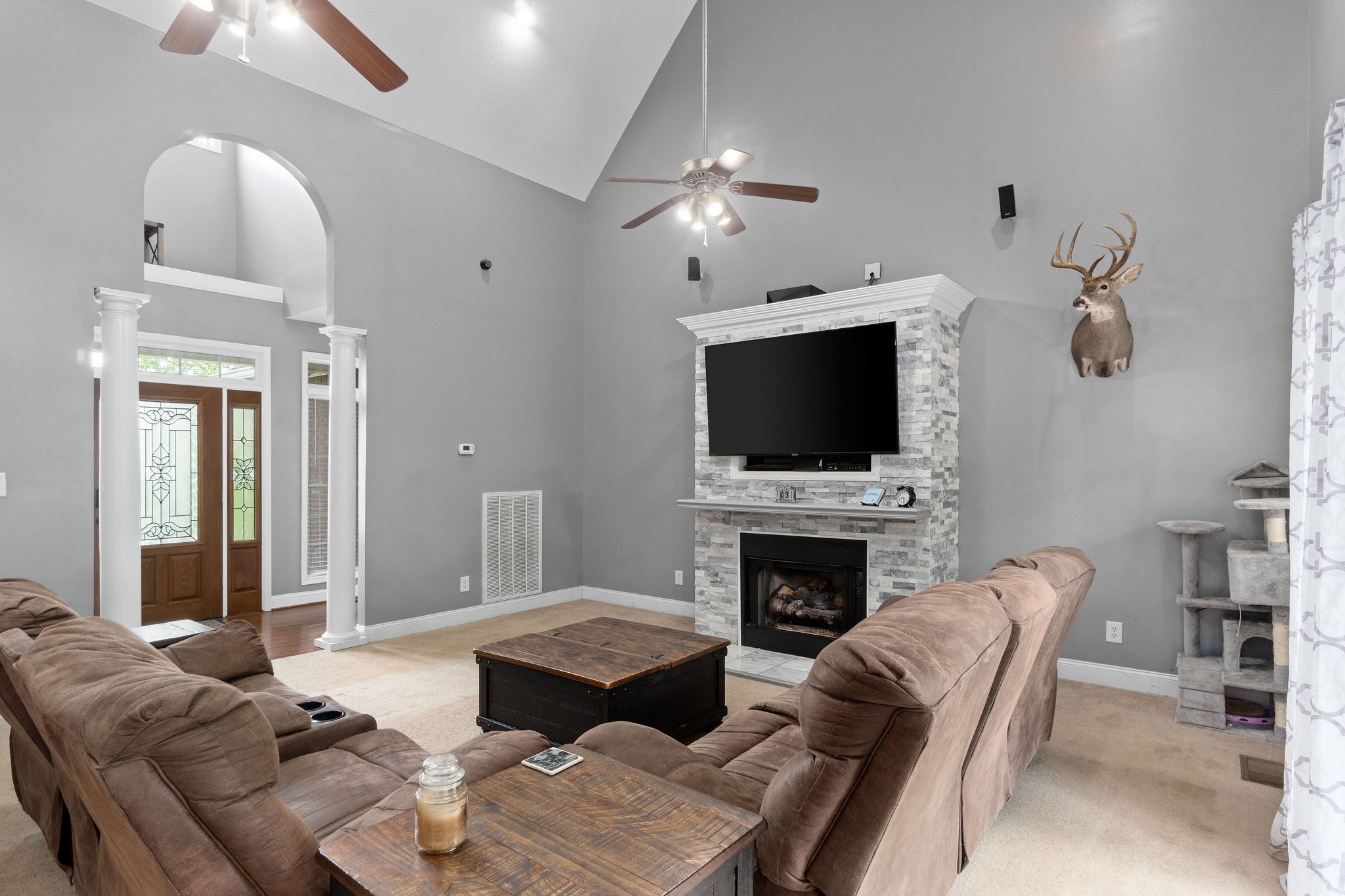 2458 Carroll Road Palmyra, TN 37142 - Photo 8 of 35 a living room with furniture a fireplace and a flat screen tv