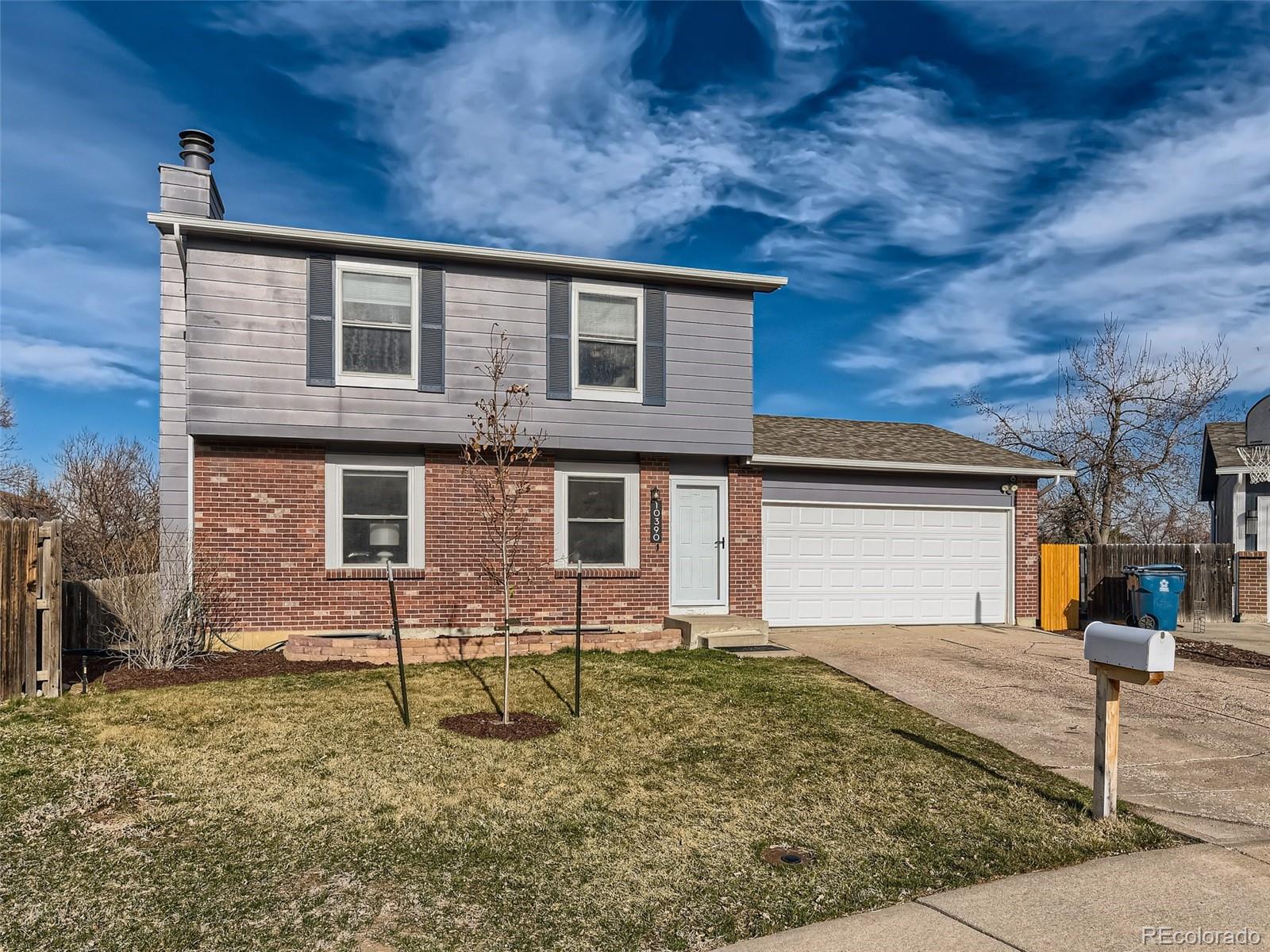 10390 Owens Circle Westminster, CO 80021 - Photo 1 of 28 a front view of a house with garden