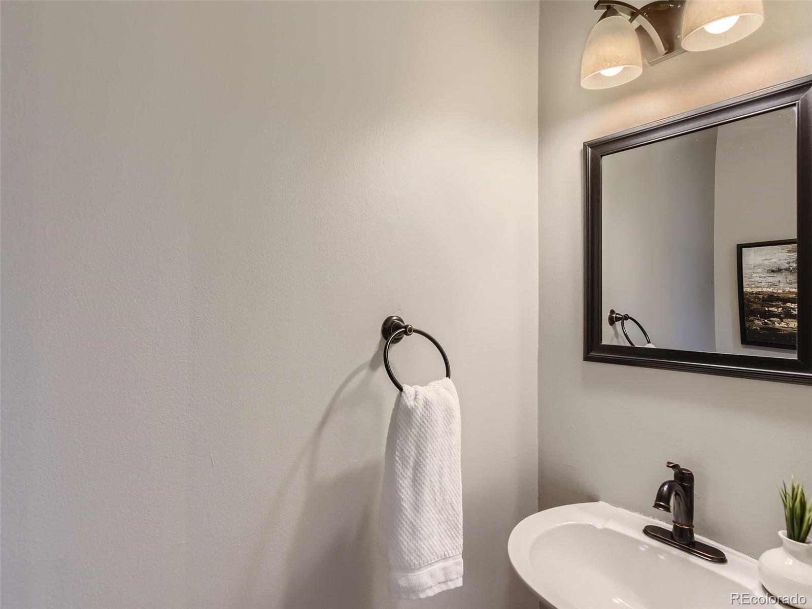 10390 Owens Circle Westminster, CO 80021 - Photo 12 of 28 a bathroom with a sink vanity and mirror