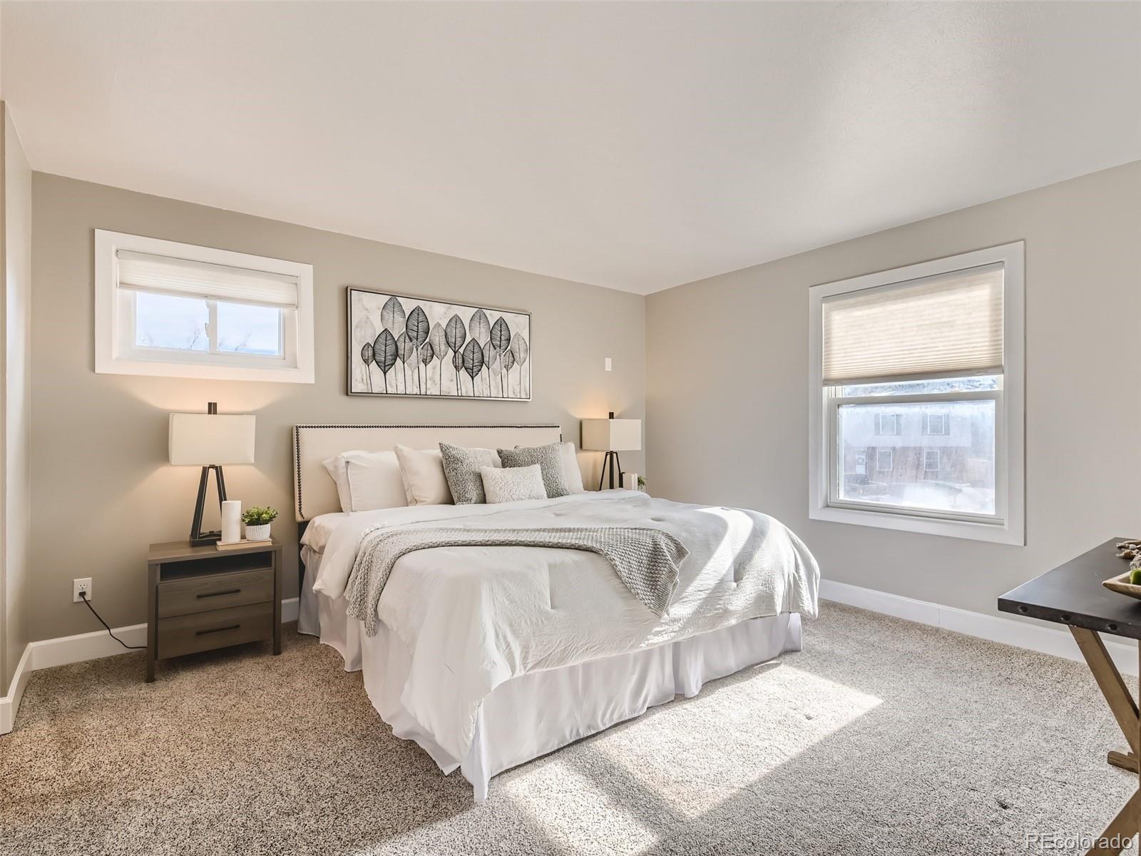 10390 Owens Circle Westminster, CO 80021 - Photo 13 of 28 a spacious bedroom with a bed and a window