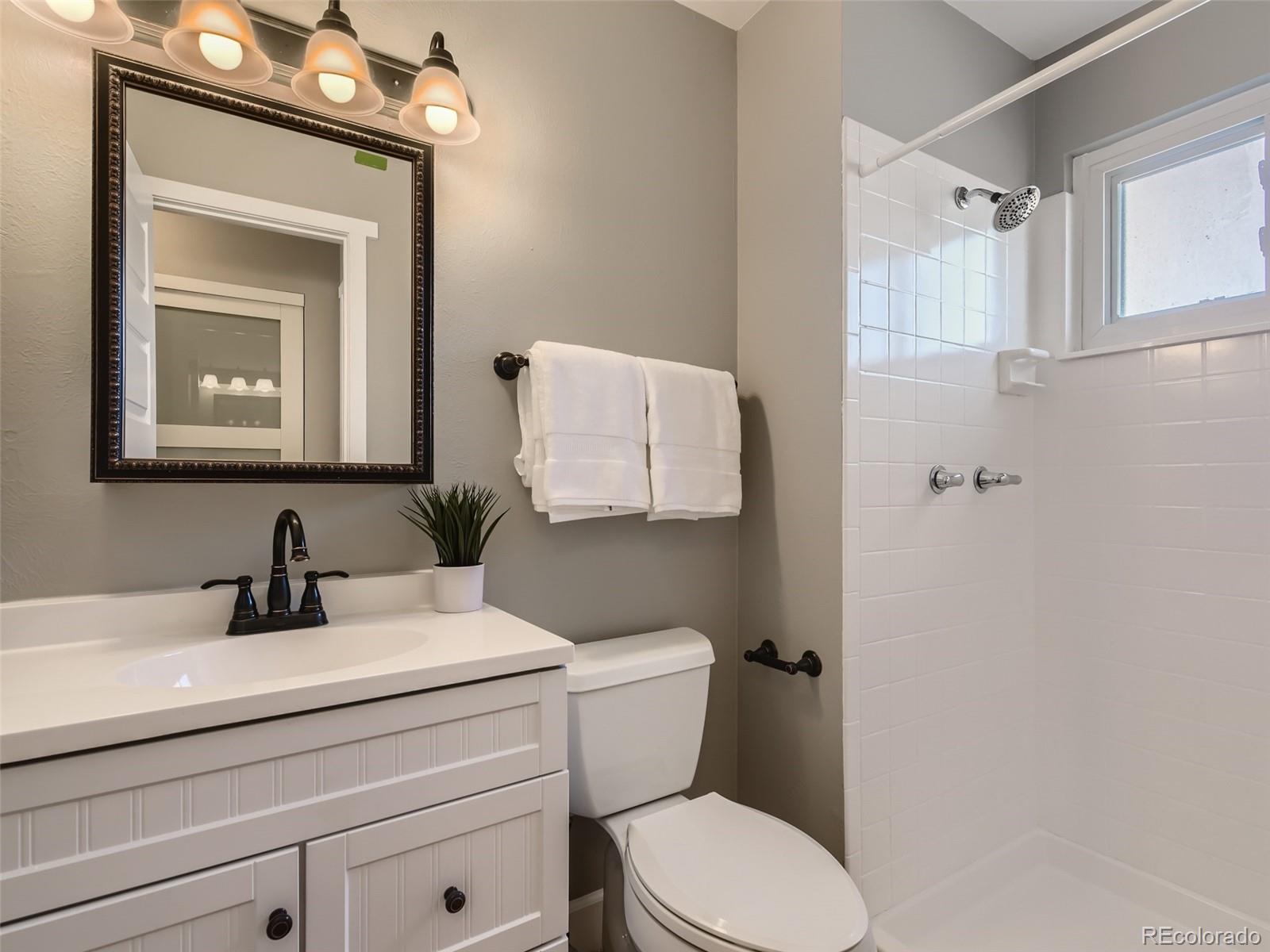 10390 Owens Circle Westminster, CO 80021 - Photo 15 of 28 a bathroom with a toilet a sink and mirror