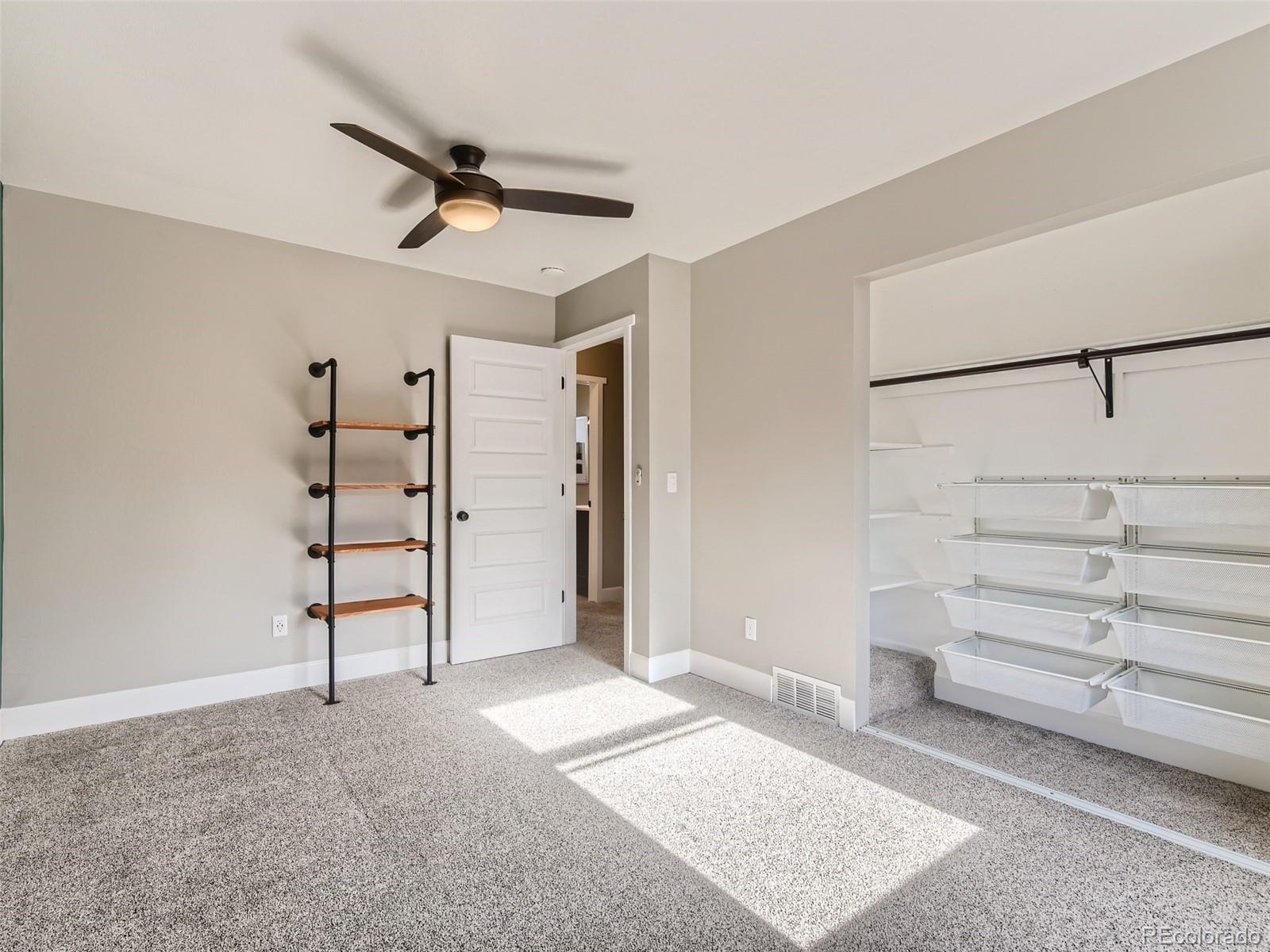 10390 Owens Circle Westminster, CO 80021 - Photo 19 of 28 a view of a livingroom with closet and a ceiling fan