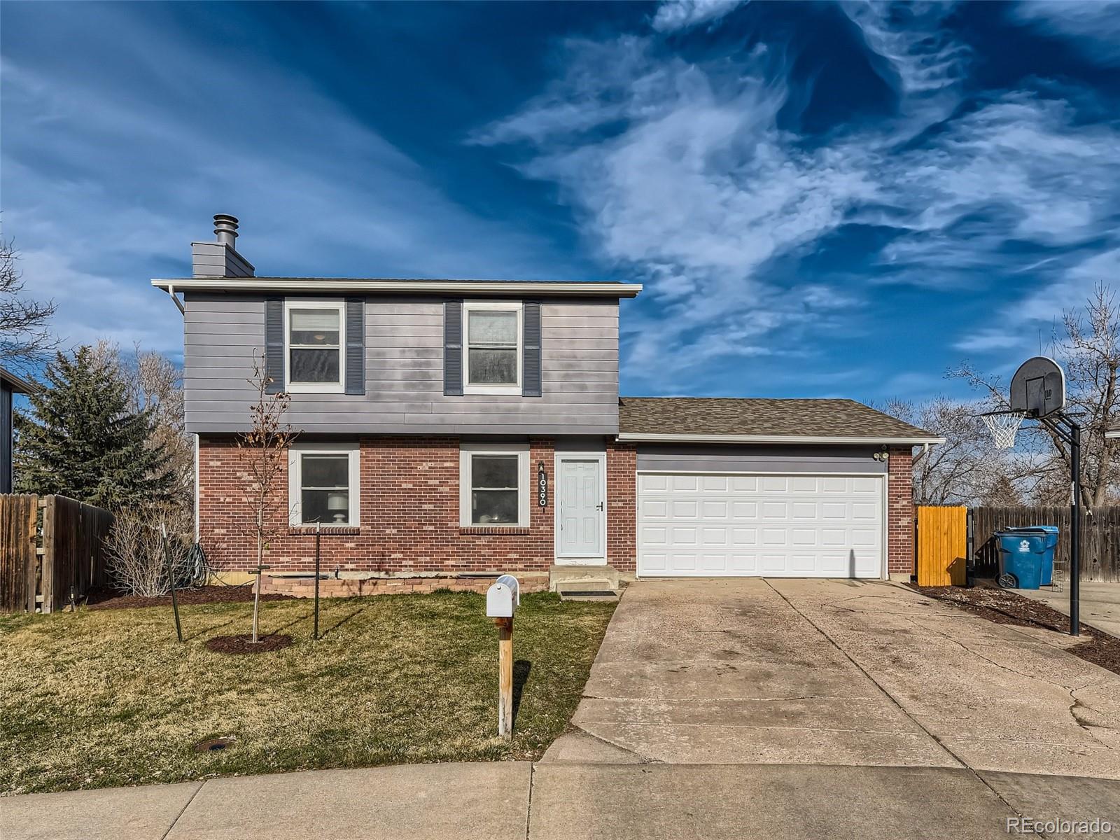 10390 Owens Circle Westminster, CO 80021 - Photo 2 of 28 a front view of a house with garden