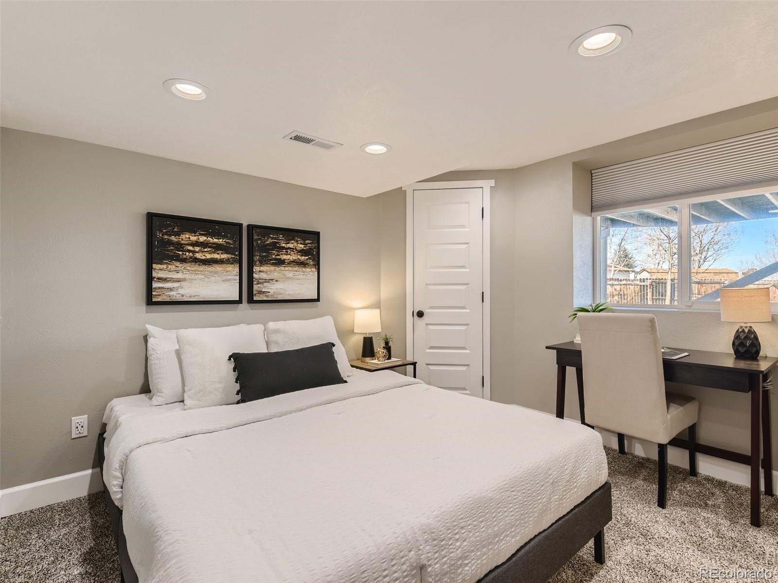 10390 Owens Circle Westminster, CO 80021 - Photo 23 of 28 a bedroom with a large bed and a table