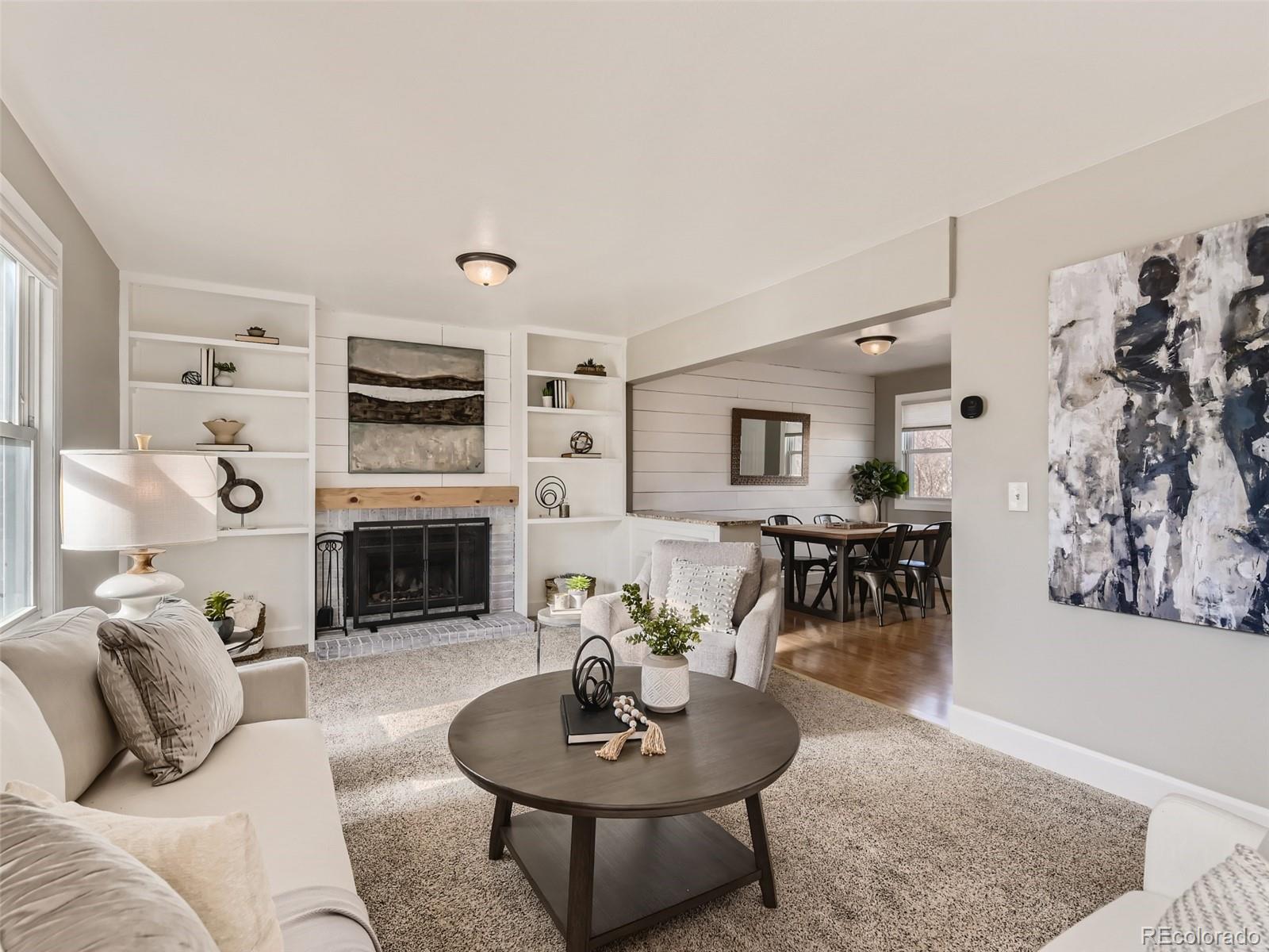 10390 Owens Circle Westminster, CO 80021 - Photo 5 of 28 a living room with furniture a table and a fireplace