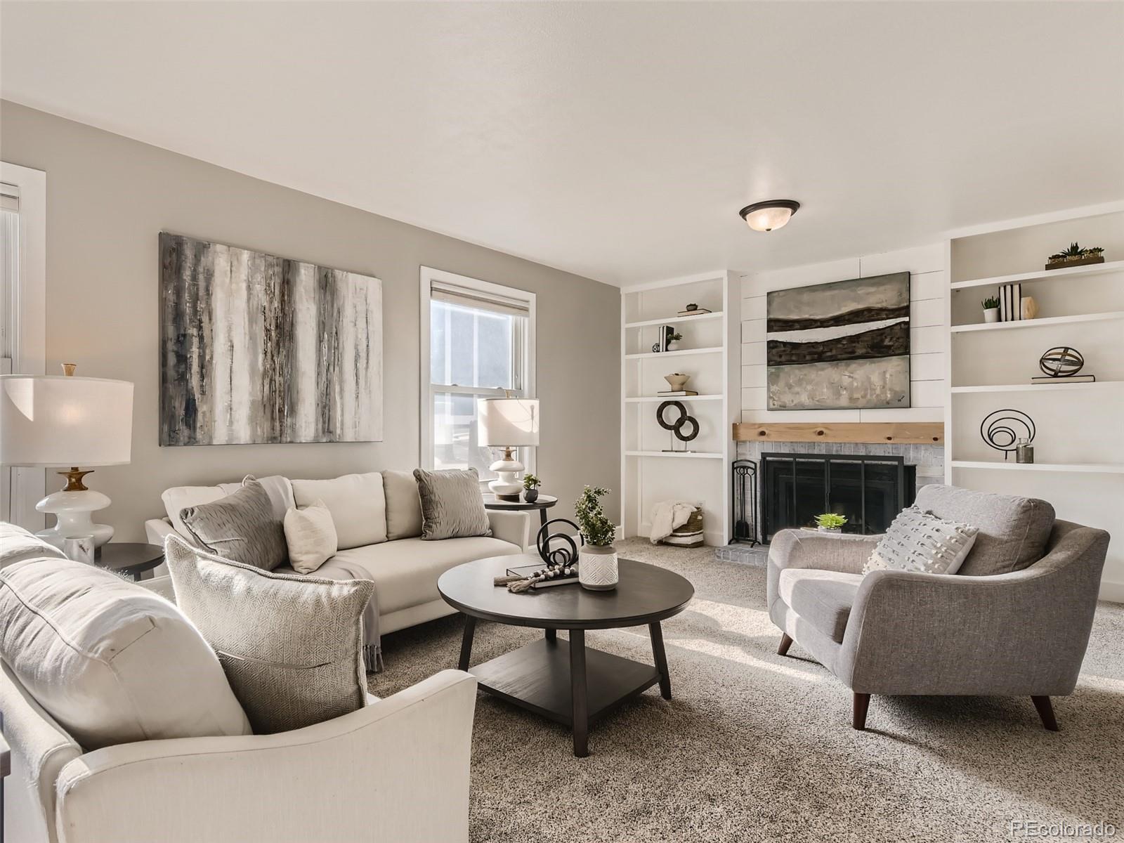 10390 Owens Circle Westminster, CO 80021 - Photo 6 of 28 a living room with furniture a fireplace and a large window