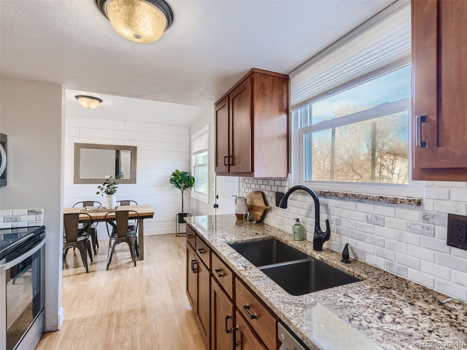 10390 Owens Circle Westminster, CO 80021 - Photo 9 of 28 a kitchen with granite countertop a sink and stove