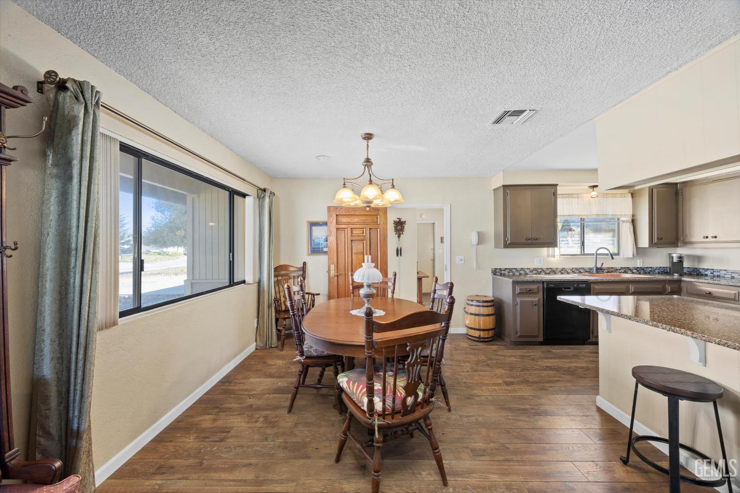 Undisclosed Address Tehachapi, CA 93561 - Photo 11 of 40 a view of a dining room with furniture window and wooden floor