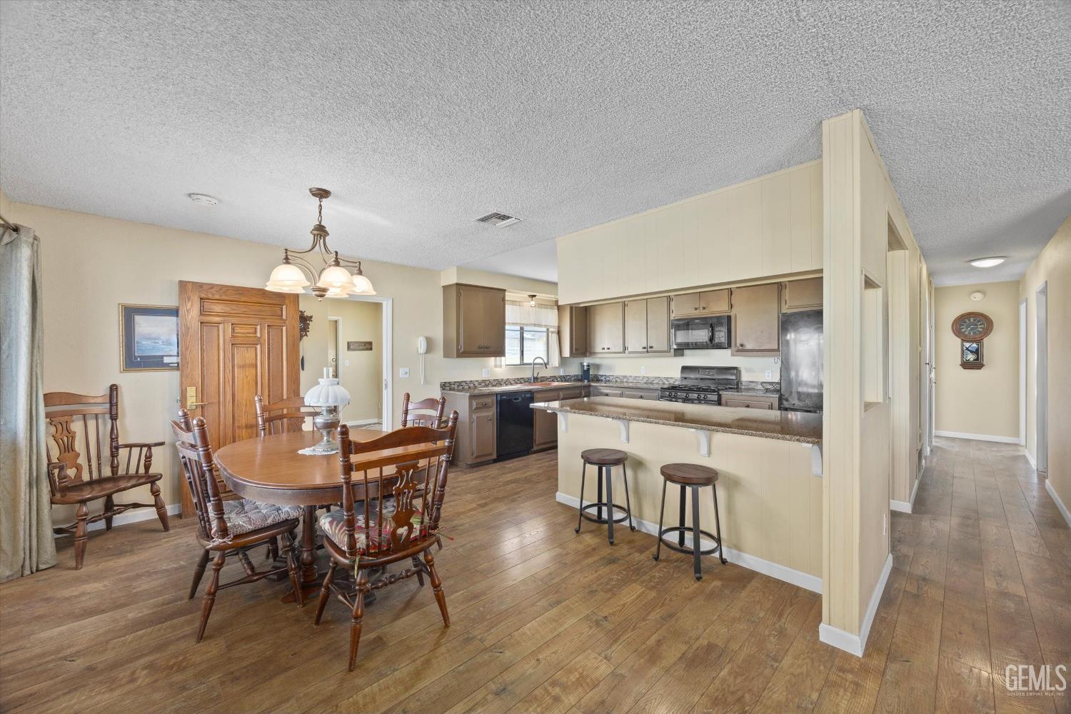 Undisclosed Address Tehachapi, CA 93561 - Photo 12 of 40 a view of a dining room with furniture and wooden floor