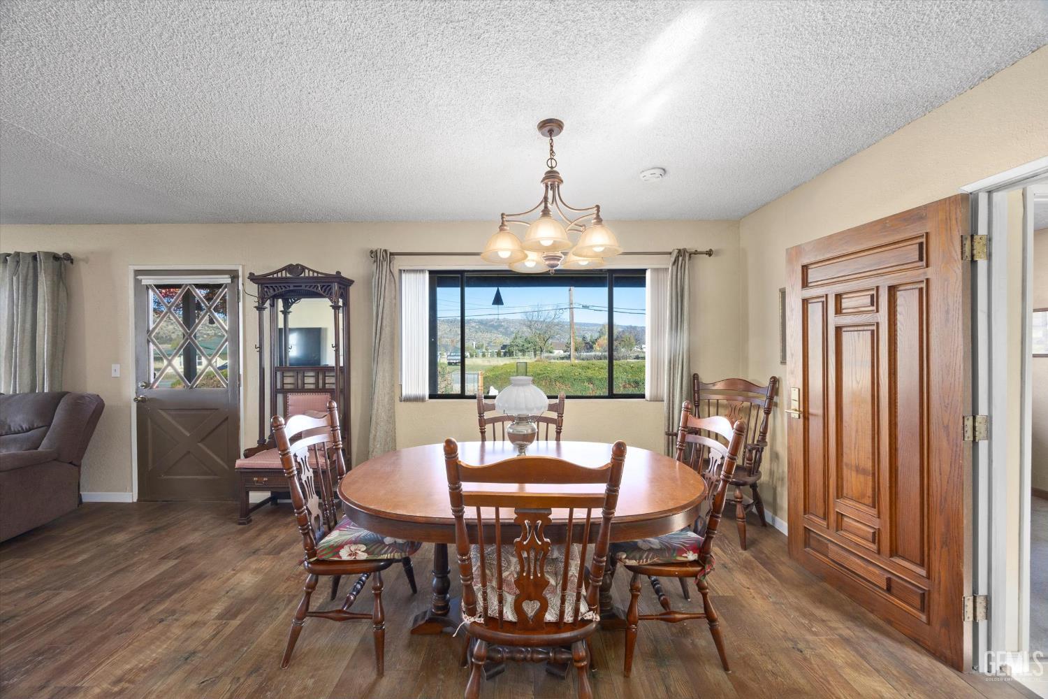 Undisclosed Address Tehachapi, CA 93561 - Photo 13 of 40 a view of a dining room with furniture window and wooden floor