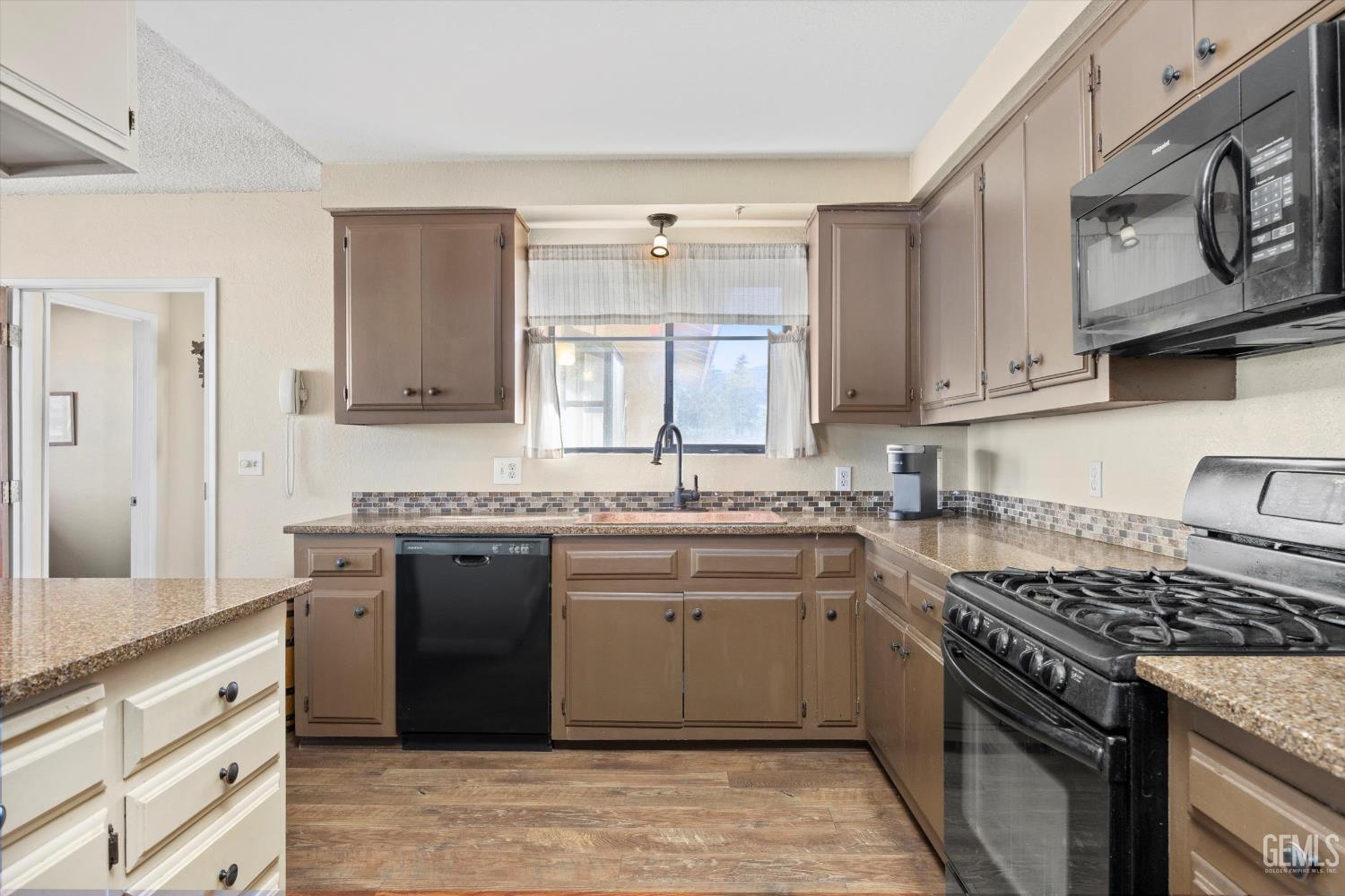 Undisclosed Address Tehachapi, CA 93561 - Photo 16 of 40 a kitchen with stainless steel appliances granite countertop a stove and a sink