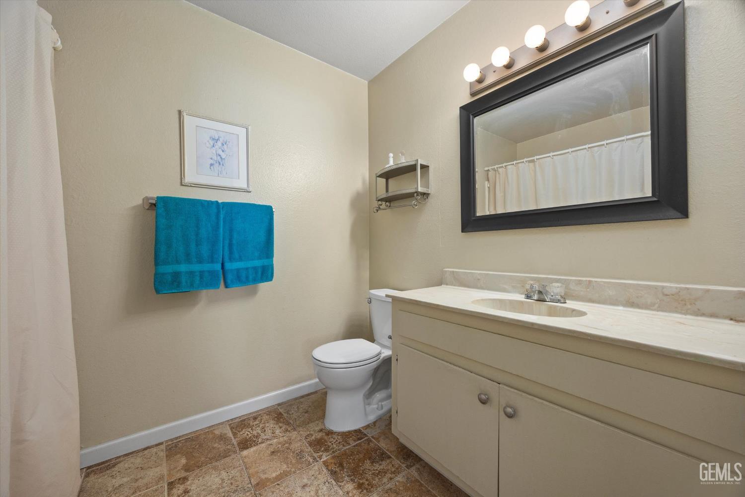 Undisclosed Address Tehachapi, CA 93561 - Photo 22 of 40 a bathroom with a toilet sink and mirror