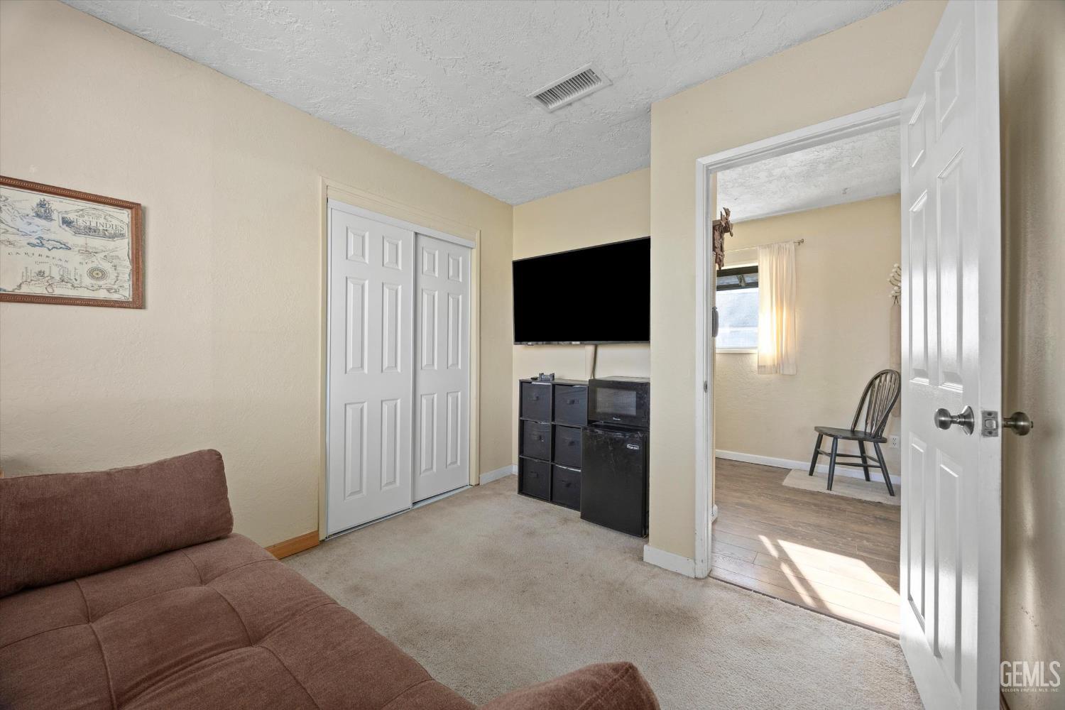 Undisclosed Address Tehachapi, CA 93561 - Photo 26 of 40 a living room with furniture and a flat screen tv