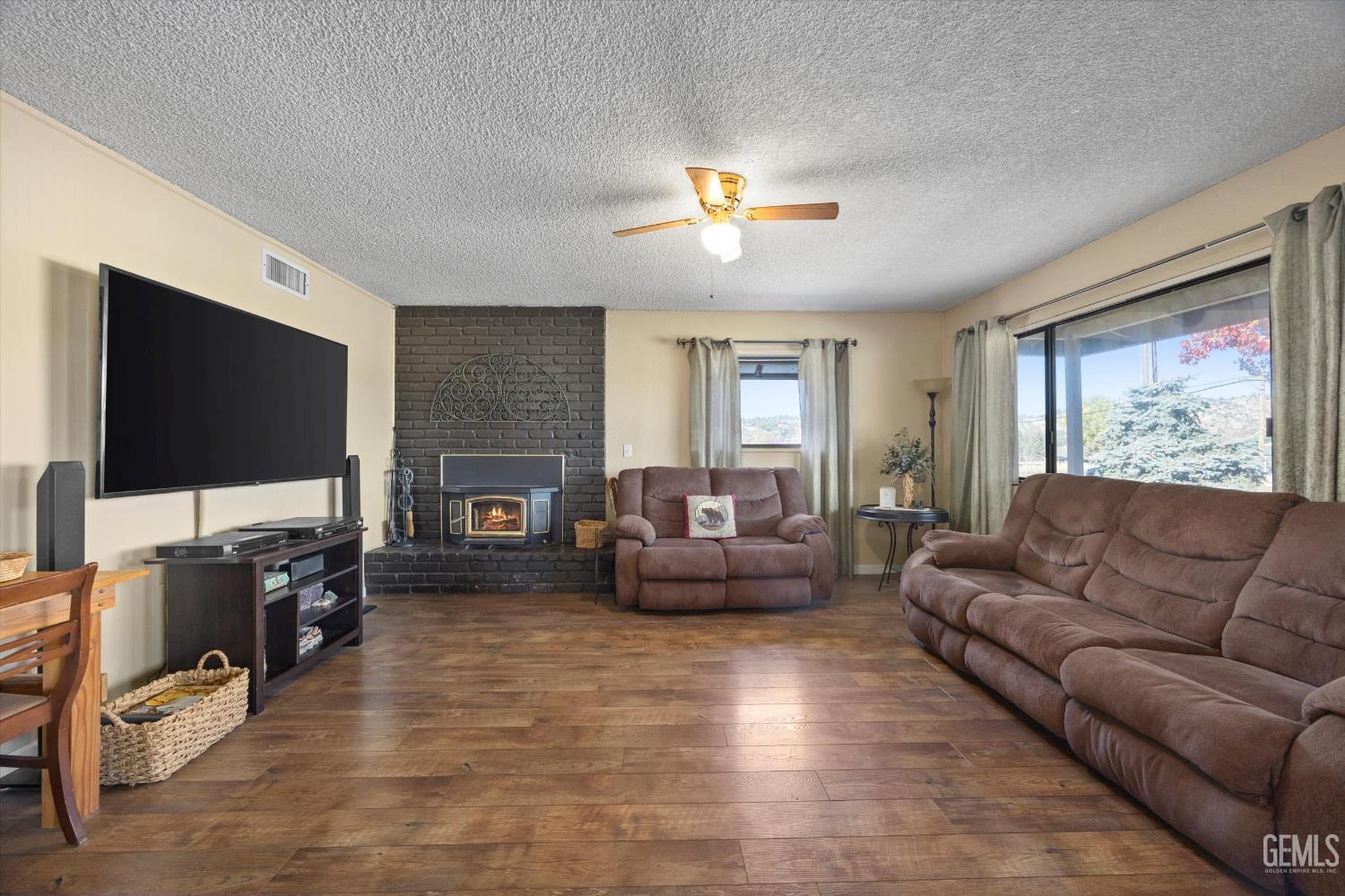 Undisclosed Address Tehachapi, CA 93561 - Photo 6 of 40 a living room with furniture a flat screen tv and a fireplace