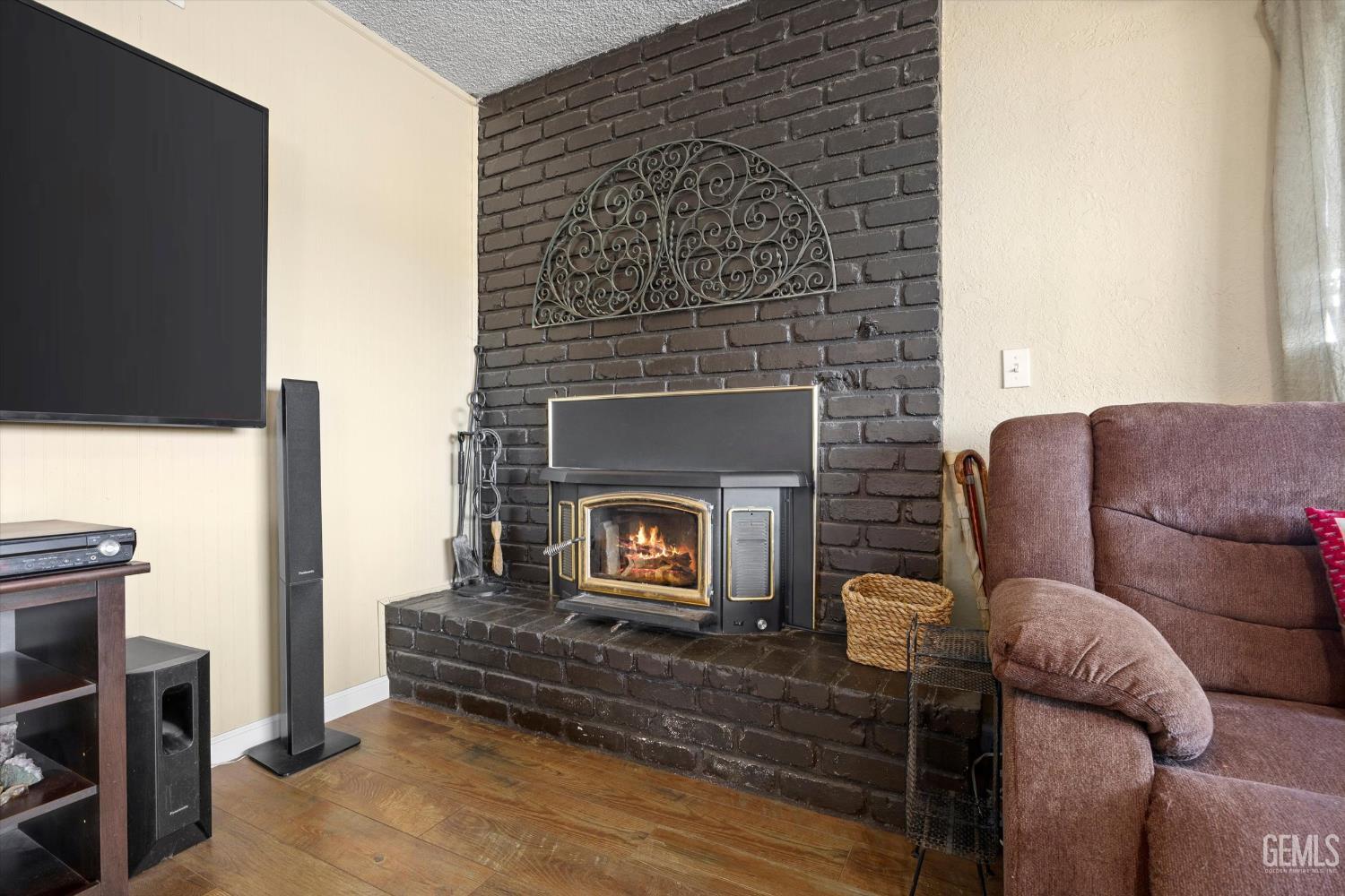 Undisclosed Address Tehachapi, CA 93561 - Photo 7 of 40 a living room with furniture a flat screen tv and a fireplace