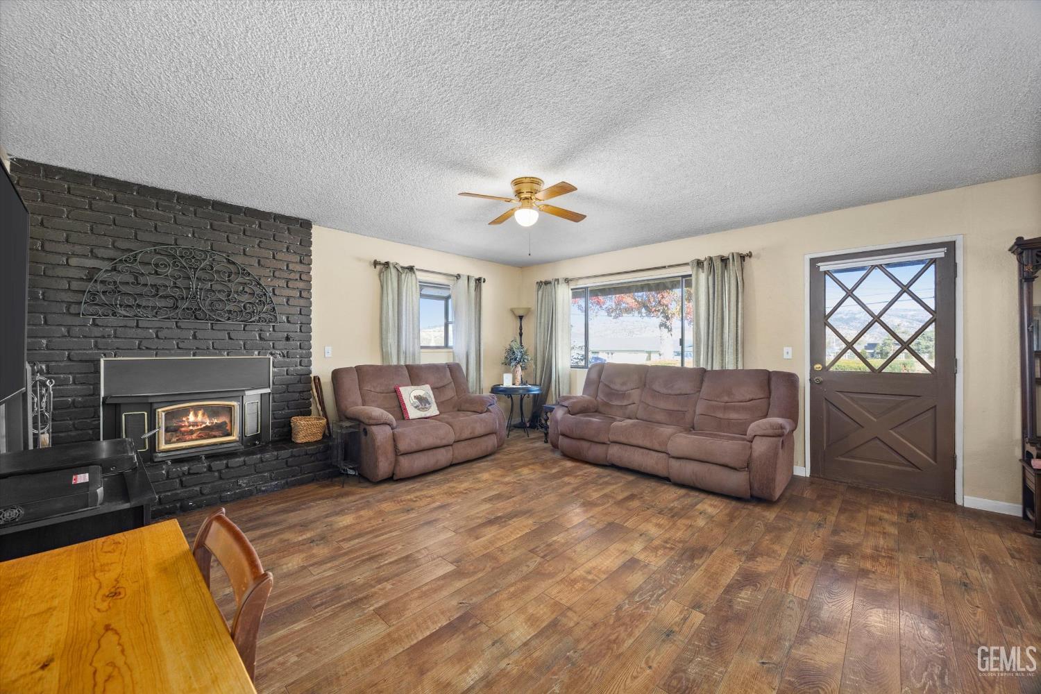 Undisclosed Address Tehachapi, CA 93561 - Photo 8 of 40 a living room with furniture and a fireplace