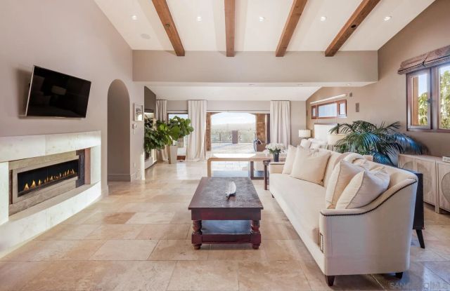 a living room with furniture fireplace and flat screen tv