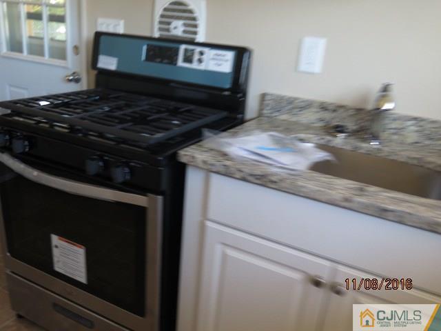 27 Clemson Road Old Bridge, NJ 08859 - Photo 15 of 18 a stove top oven sitting inside of a kitchen