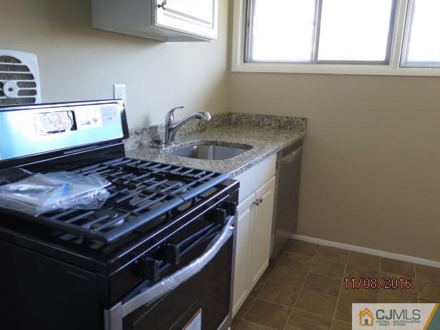 27 Clemson Road Old Bridge, NJ 08859 - Photo 3 of 18 a stove top oven sitting inside of a kitchen