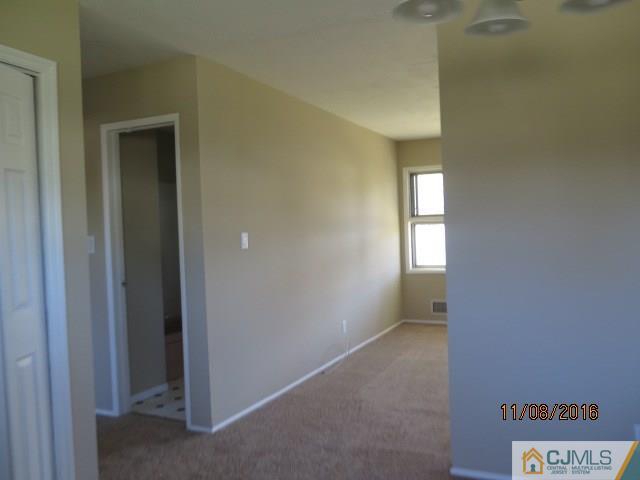 27 Clemson Road Old Bridge, NJ 08859 - Photo 5 of 18 a view of an empty room and window