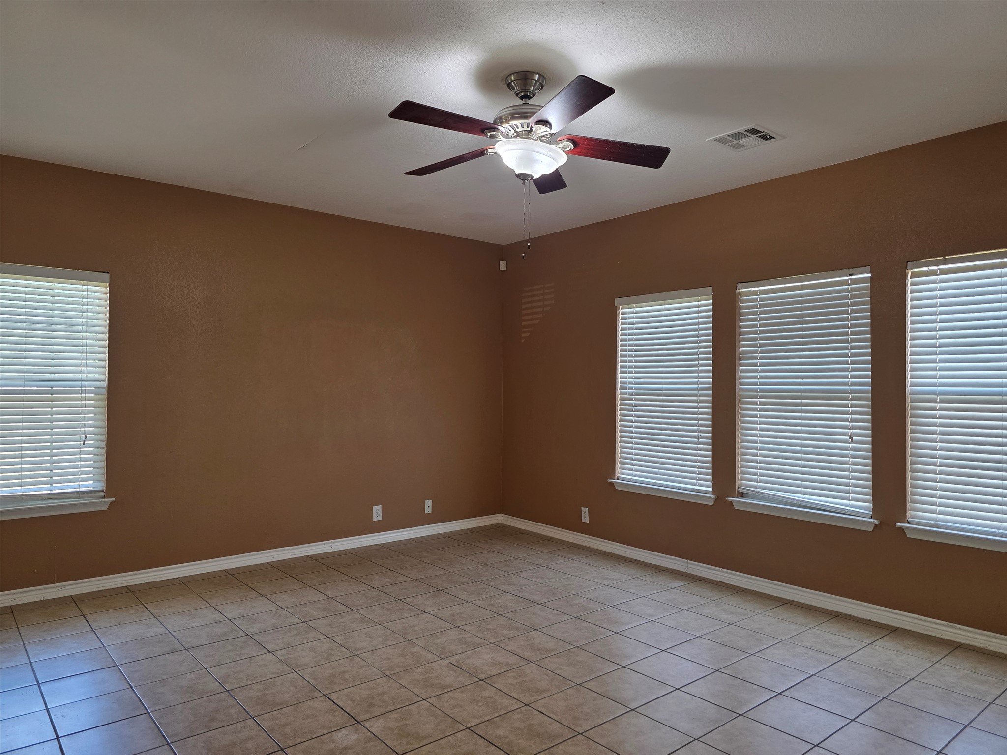 189 Ruidoso Road Kyle, TX 78640 - Photo 7 of 31 A versatile living space with clean lines, tile flooring, and ample natural light from multiple windows.