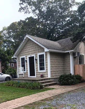 a view of front of house with a yard