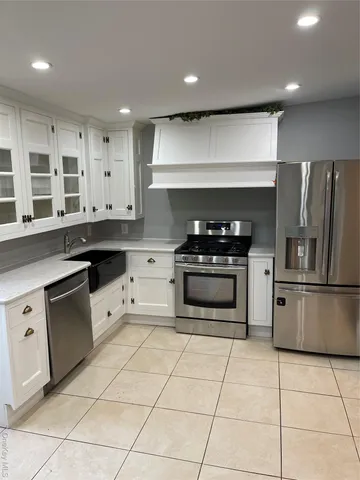 a kitchen with cabinets and steel stainless steel appliances
