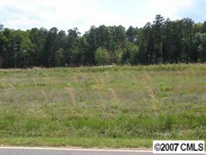 a view of a field with trees in the background