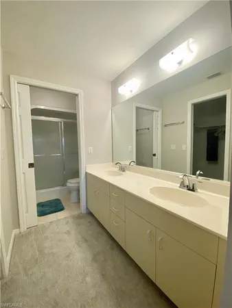 a bathroom with a sink mirror and a bath tub