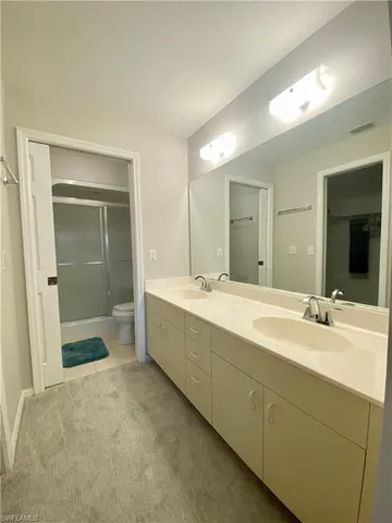 a bathroom with a sink mirror and a bath tub