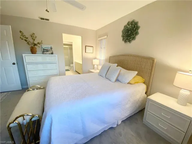 a bedroom with a bed and chair